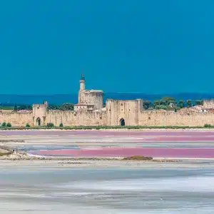 Aigues-Mortes fortified city with pink salt marshes in Camargue, France
