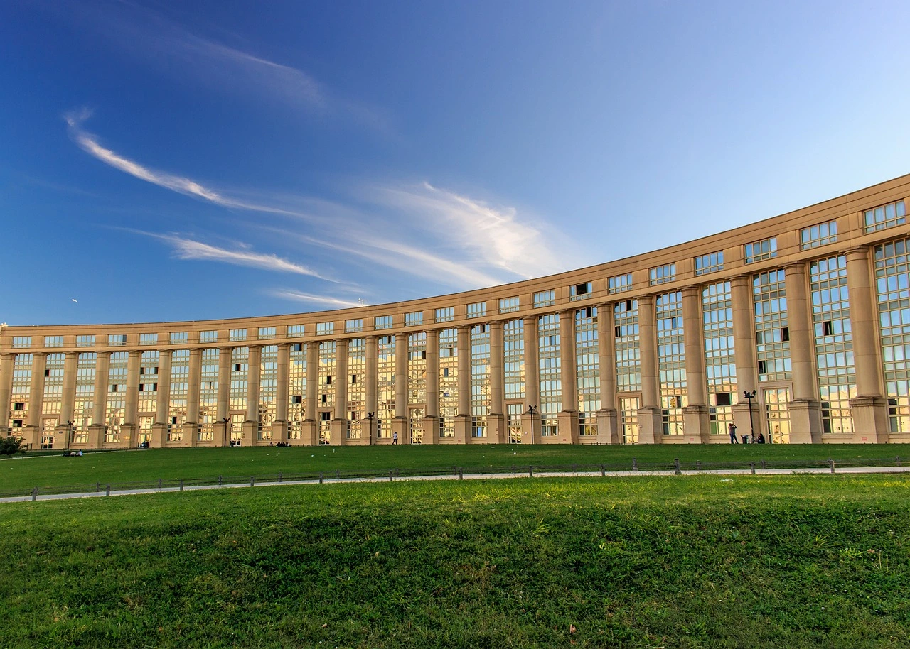 Antigone district in Montpellier with neoclassical architecture and green park under a blue sky