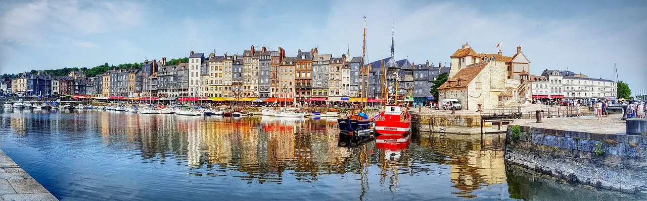 Colorful historic buildings and boats at the Old Port of Honfleur in Normandy, France