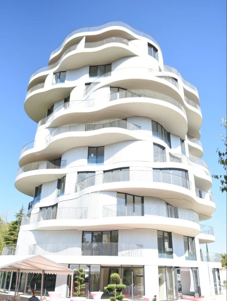 Contemporary white residential building with wave-like balconies in Montpellier, France