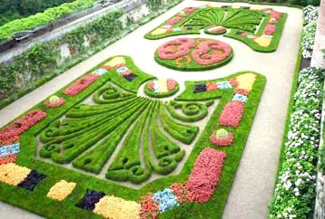 Formal gardens of the Palais de la Berbie in Albi with colorful flower beds and elegant designs near Toulouse