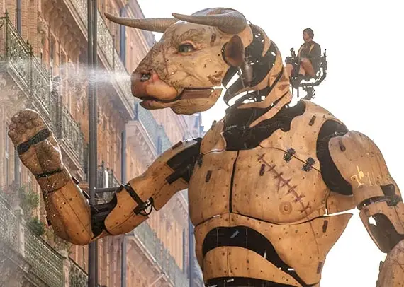 Giant mechanical Minotaur spraying water during a parade in Toulouse, France