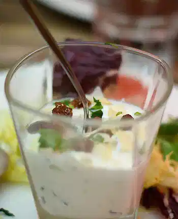 Gourmet verrine starter served in a glass with herbs and cream, typical of French cuisine in Lyon