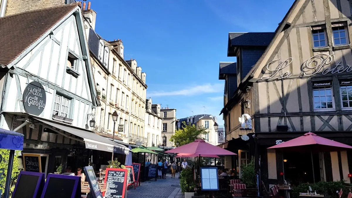 Historic street with timber-framed houses and cafés in Caen, Normandy