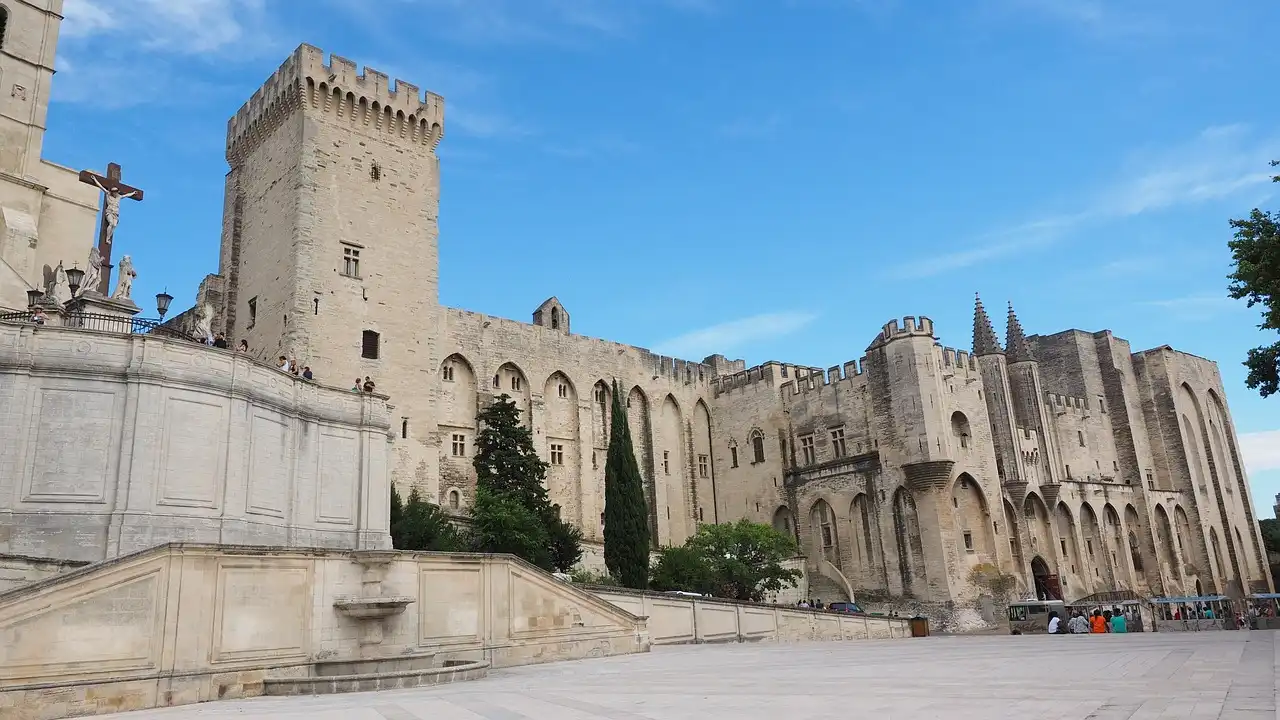 Palais des Papes in Avignon, France, medieval Gothic architecture under blue sky