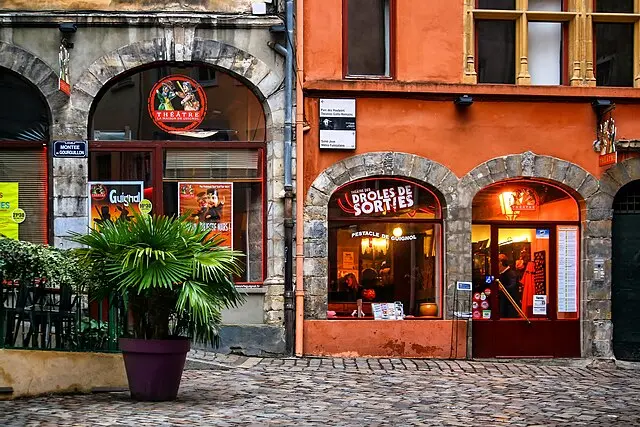 Small local theatre in Old Lyon with colourful façade and posters, promoting French shows and comedy events