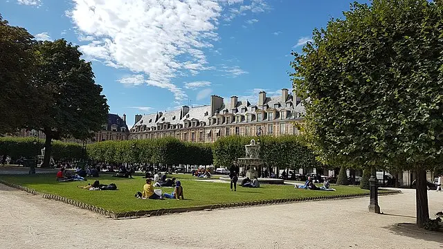 Students relaxing at Place des Vosges during a French language and culture lesson in Paris