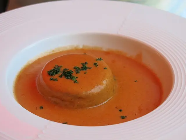 Traditional Lyon quenelle of pike with Nantua sauce, served in a white plate