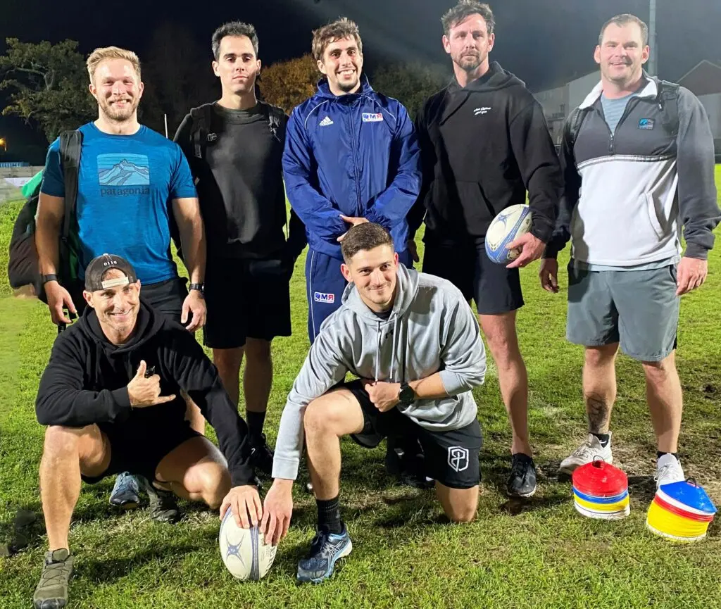 Group of men during a rugby training session in Bordeaux at night
