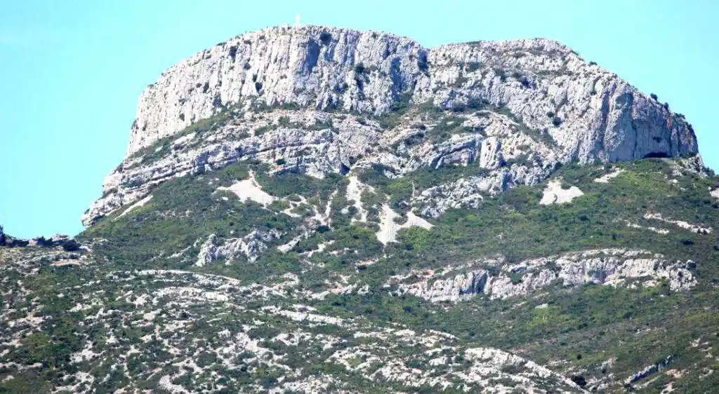 Panoramic view of the Sainte-Baume massif with limestone cliffs and green vegetation in Provence