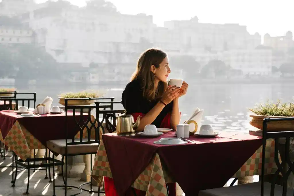 Student enjoying a coffee by the sea during a French immersion in Nice