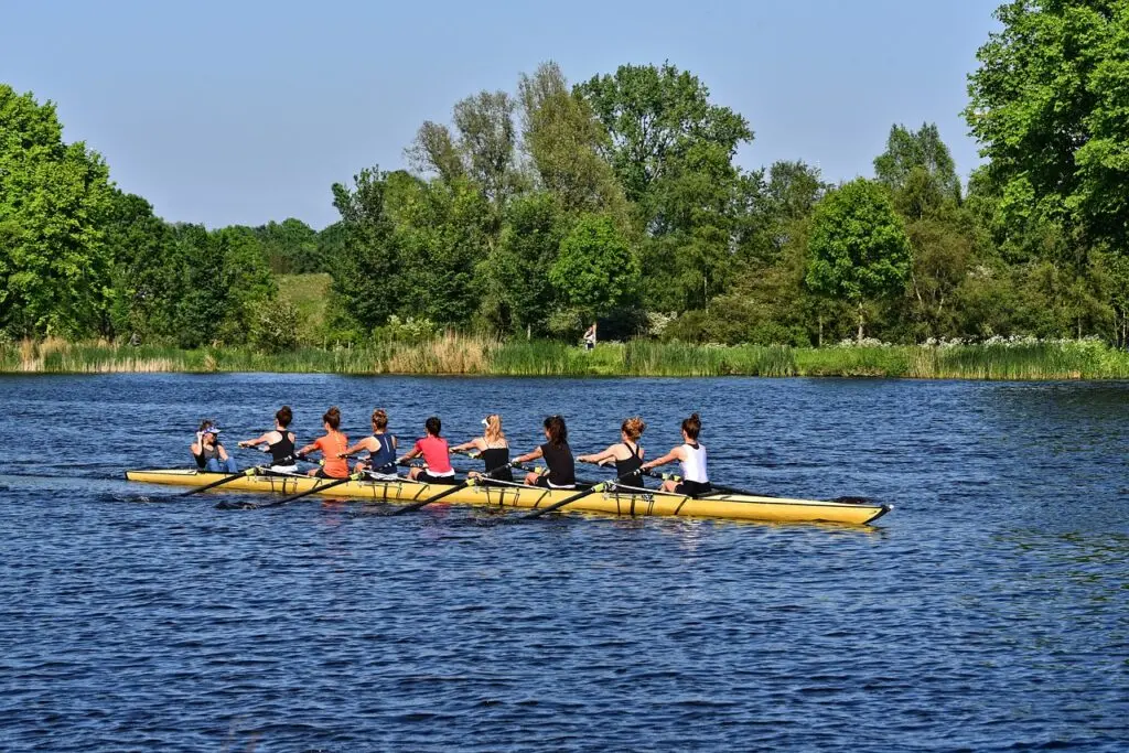 Team of rowers practicing on a river – group rowing activity in nature