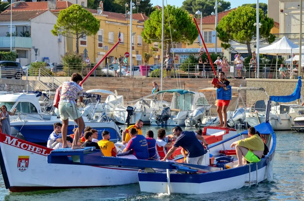 Traditional water jousting event in Montpellier with participants in boats on the canal