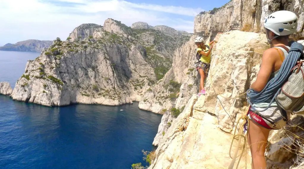 Two climbers on a cliff in the Calanques near Marseille overlooking the Mediterranean Sea